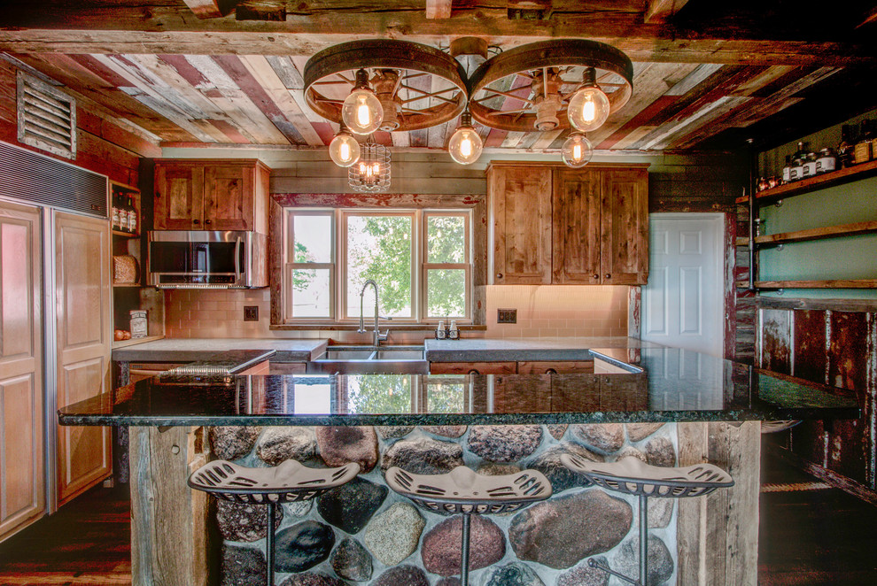 Example of a small mountain style galley medium tone wood floor eat-in kitchen design in Milwaukee with recessed-panel cabinets, light wood cabinets, an island, a farmhouse sink, concrete countertops, beige backsplash, ceramic backsplash and paneled appliances
