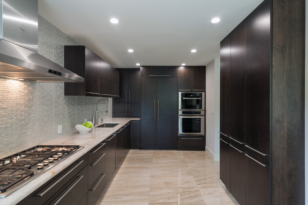 Mid-sized modern l-shaped eat-in kitchen in Miami with flat-panel cabinets, dark wood cabinets, metallic splashback, glass tile splashback, stainless steel appliances and with island.