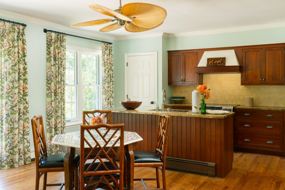 Exempel på ett mellanstort eklektiskt brun brunt l-kök, med en undermonterad diskho, skåp i shakerstil, skåp i mellenmörkt trä, granitbänkskiva, beige stänkskydd, stänkskydd i keramik, rostfria vitvaror, ljust trägolv, en köksö och brunt golv