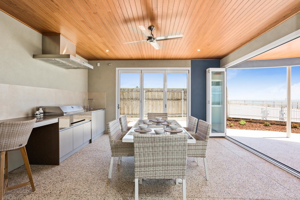 This is an example of a mid-sized beach style patio in Perth with a roof extension.