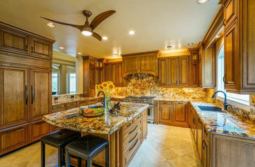 Eat-in kitchen - large rustic u-shaped travertine floor eat-in kitchen idea in Denver with a double-bowl sink, dark wood cabinets, granite countertops, stone slab backsplash, paneled appliances, an island, raised-panel cabinets and multicolored backsplash