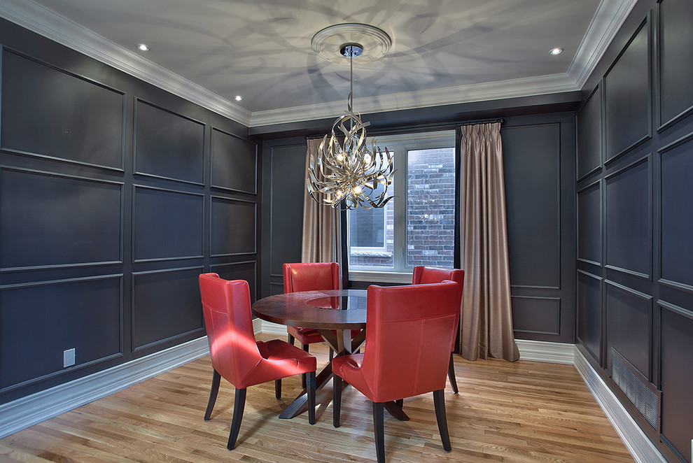Contemporary separate dining room in Toronto with black walls and medium hardwood floors.