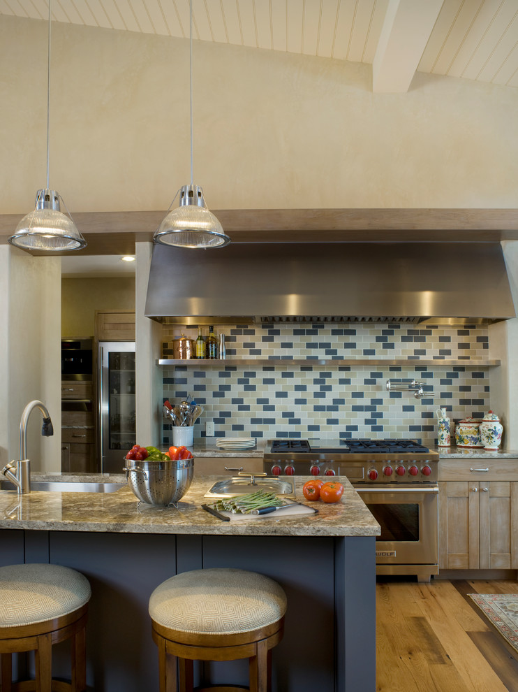 Inspiration for a huge rustic galley medium tone wood floor eat-in kitchen remodel in Denver with an undermount sink, light wood cabinets, multicolored backsplash, mosaic tile backsplash, stainless steel appliances, an island and granite countertops