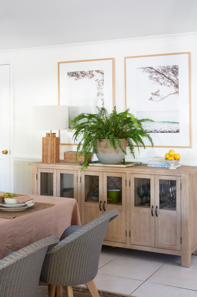 Design ideas for a mid-sized beach style kitchen/dining combo in Brisbane with white walls, medium hardwood floors and grey floor.