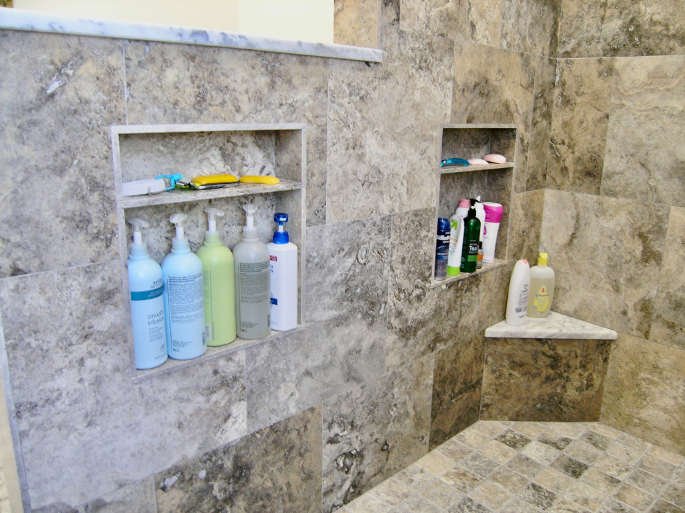 Photo of a large traditional master bathroom in Tampa with shaker cabinets, white cabinets, a freestanding tub, a curbless shower, a one-piece toilet, gray tile, travertine, grey walls, travertine floors, an undermount sink, engineered quartz benchtops, grey floor, an open shower and grey benchtops.