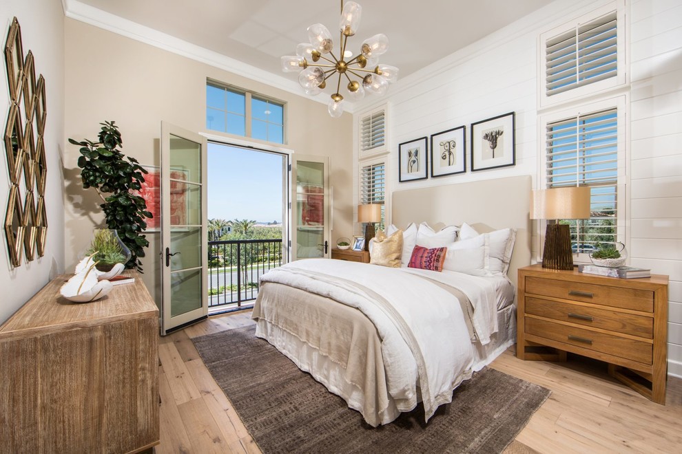Large transitional guest bedroom in Orange County with beige walls, light hardwood floors and beige floor.
