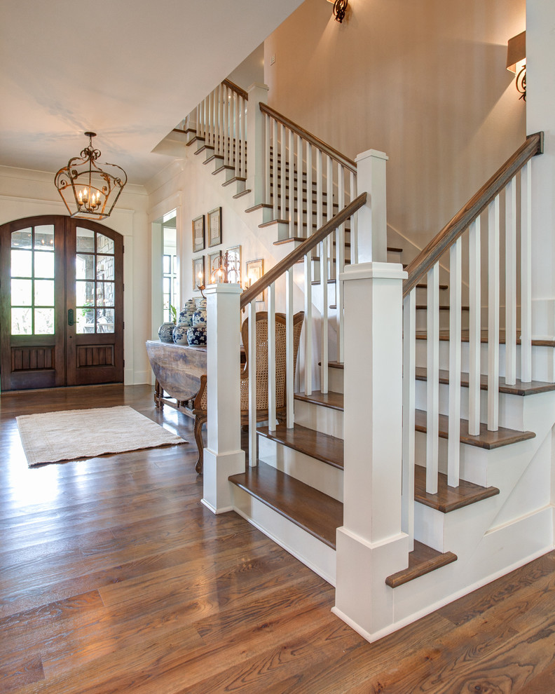 Inspiration for a mid-sized traditional wood l-shaped staircase in Little Rock with painted wood risers and wood railing.