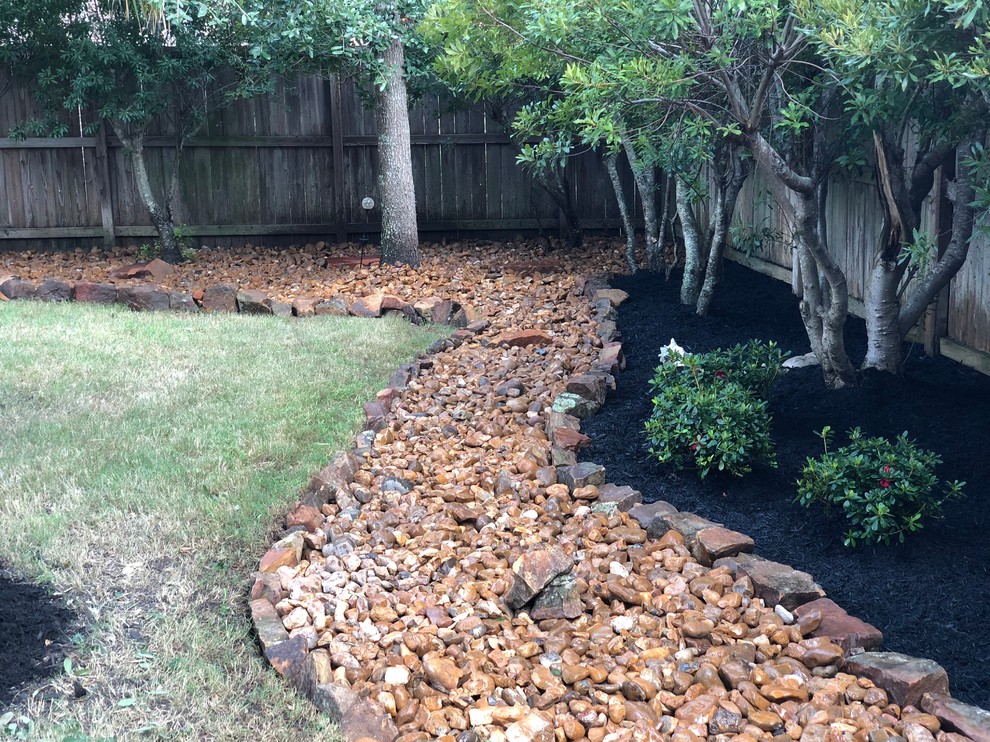 Inspiration for a rustic partial sun backyard landscaping in Houston.