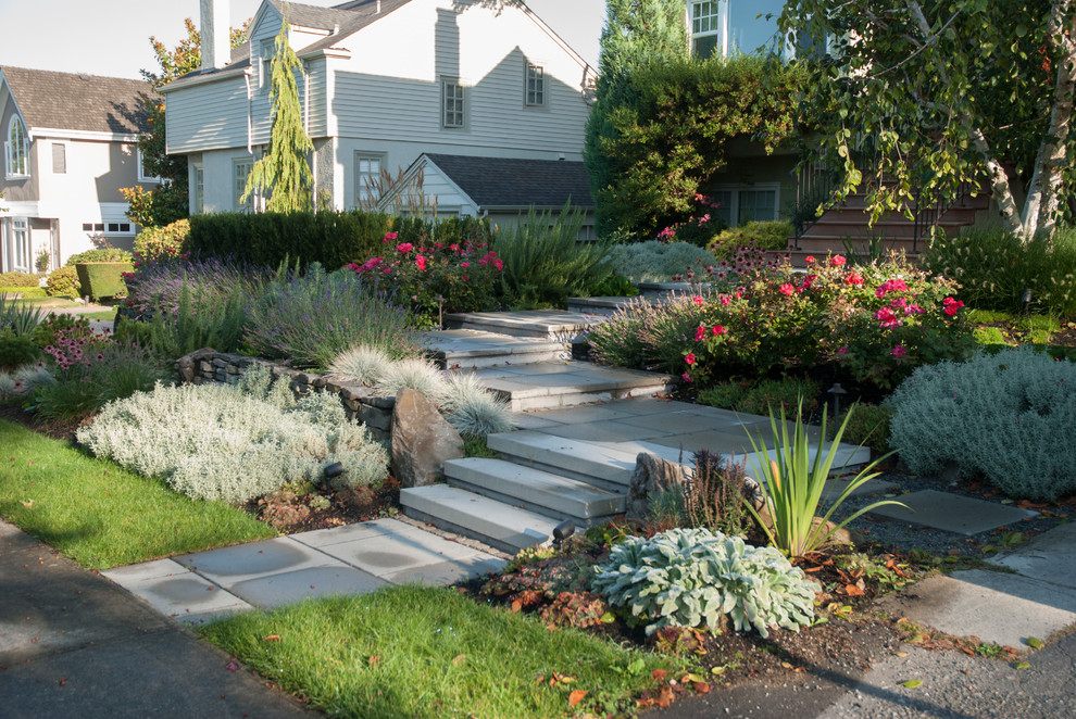 Large contemporary front yard full sun garden in Vancouver with a garden path and natural stone pavers.