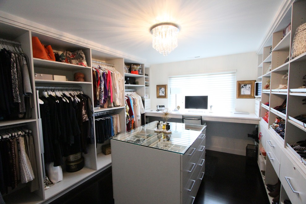 Photo of a mid-sized transitional women's walk-in wardrobe in Detroit with open cabinets, white cabinets, dark hardwood floors and brown floor.