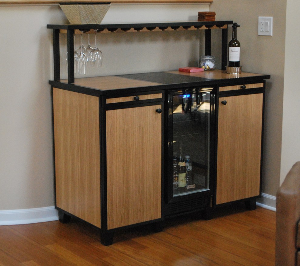 Photo of a mid-sized contemporary bar cart in New York with flat-panel cabinets, light wood cabinets, tile benchtops and medium hardwood floors.