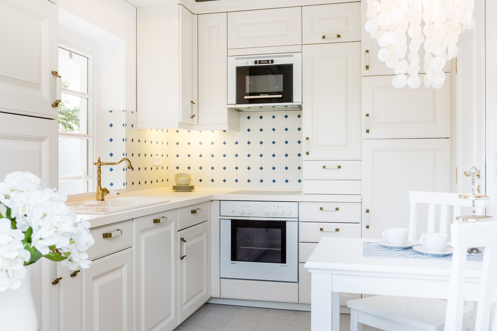 Inspiration for a small country l-shaped separate kitchen in Other with raised-panel cabinets, white cabinets, white appliances, no island, a drop-in sink, multi-coloured splashback and ceramic splashback.