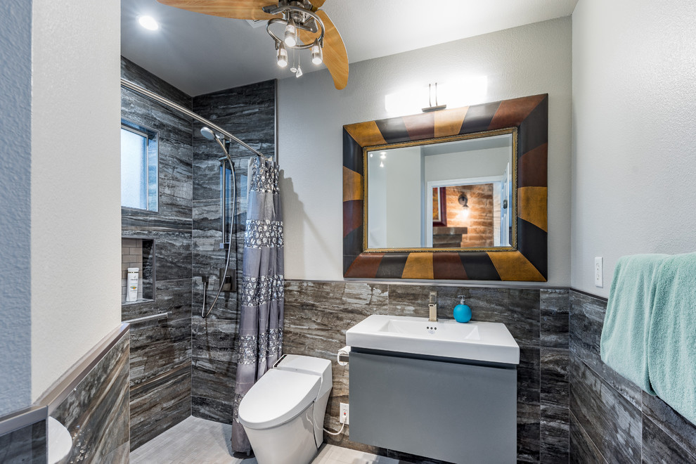 Inspiration for a small modern 3/4 bathroom in Other with flat-panel cabinets, grey cabinets, a curbless shower, a bidet, black and white tile, limestone, white walls, vinyl floors, a console sink, quartzite benchtops, grey floor, an open shower and white benchtops.