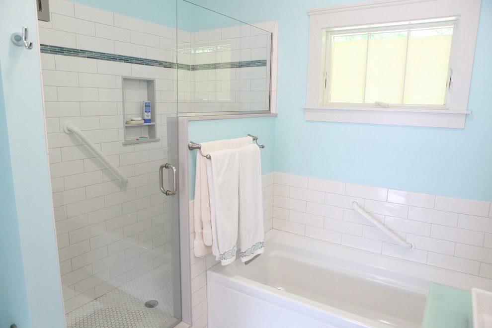 Photo of a mid-sized traditional master bathroom in Providence with flat-panel cabinets, grey cabinets, a corner tub, a corner shower, a one-piece toilet, white tile, subway tile, blue walls, mosaic tile floors, a vessel sink, glass benchtops, white floor, a hinged shower door and green benchtops.