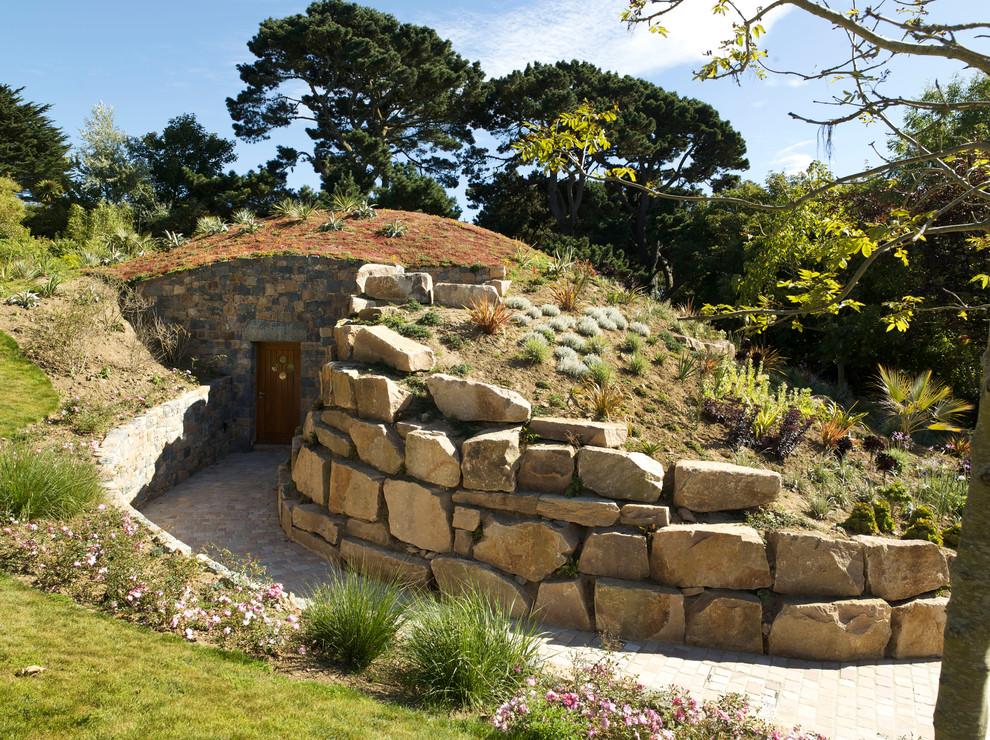 This is an example of a country garden in Channel Islands with natural stone pavers.
