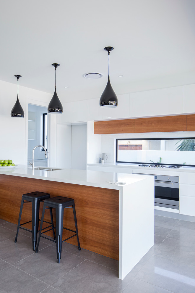 Inspiration for a contemporary galley eat-in kitchen in Gold Coast - Tweed with with island.