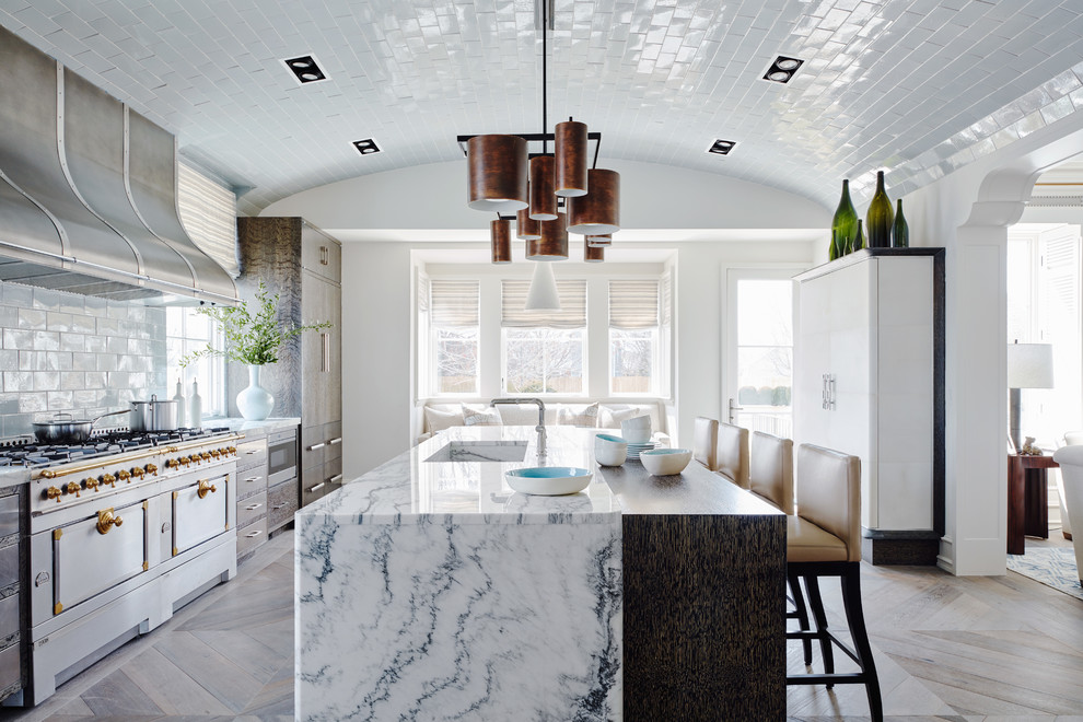 Photo of a large transitional eat-in kitchen in New York with medium wood cabinets, marble benchtops, white splashback, subway tile splashback, stainless steel appliances, medium hardwood floors, with island and an integrated sink.