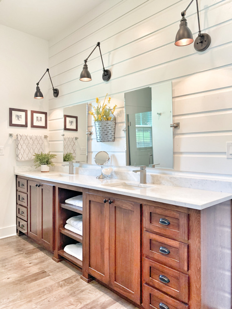 Country master bathroom with shaker cabinets, brown cabinets, white walls, vinyl floors, an undermount sink, marble benchtops, grey floor, white benchtops, a double vanity, a built-in vanity and planked wall panelling.