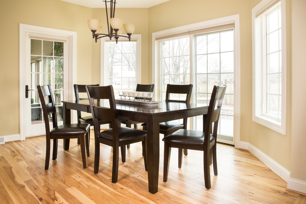 Enclosed dining room - mid-sized transitional light wood floor enclosed dining room idea in Milwaukee with beige walls and no fireplace