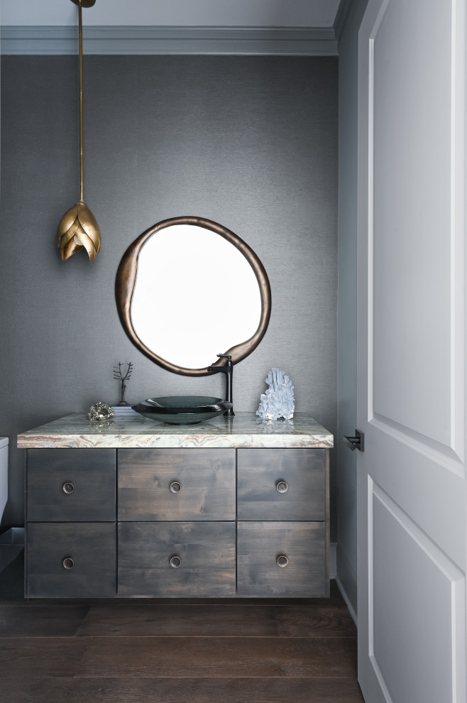 This is an example of a small traditional cloakroom in Houston with flat-panel cabinets, dark wood cabinets, grey walls, medium hardwood flooring, a vessel sink, granite worktops, brown floors, beige worktops, a floating vanity unit and wallpapered walls.