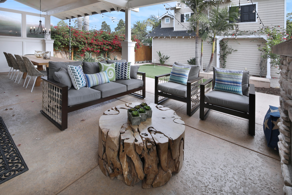 Design ideas for a mid-sized beach style backyard patio in San Diego with stamped concrete.