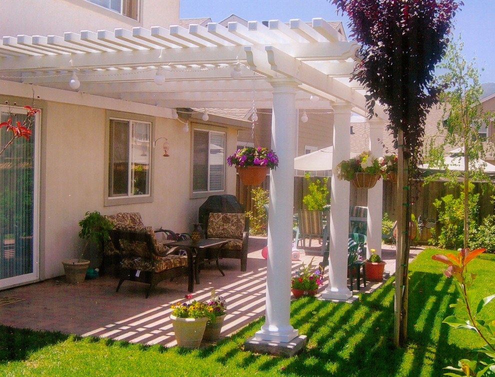 Mid-sized traditional backyard patio in San Francisco with a vertical garden, brick pavers and a pergola.
