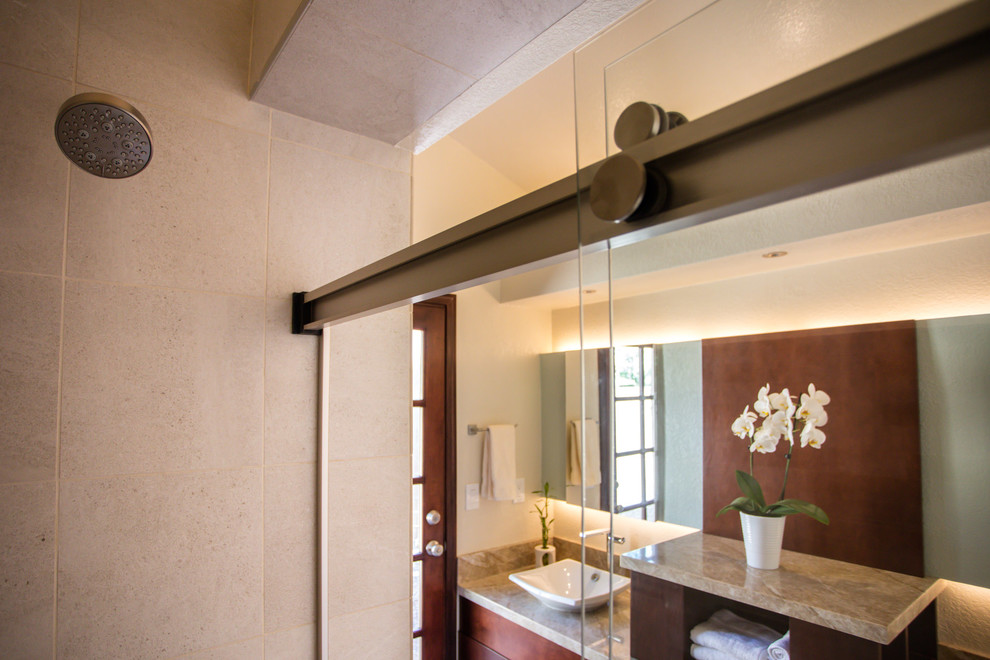 Inspiration for a small transitional beige tile and porcelain tile porcelain tile and beige floor alcove bathtub remodel in Phoenix with flat-panel cabinets, medium tone wood cabinets, a one-piece toilet, beige walls, a vessel sink and granite countertops