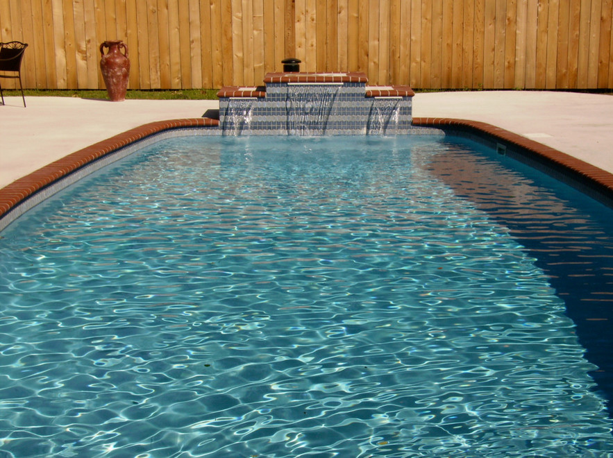 Example of a large transitional backyard concrete and custom-shaped hot tub design in St Louis