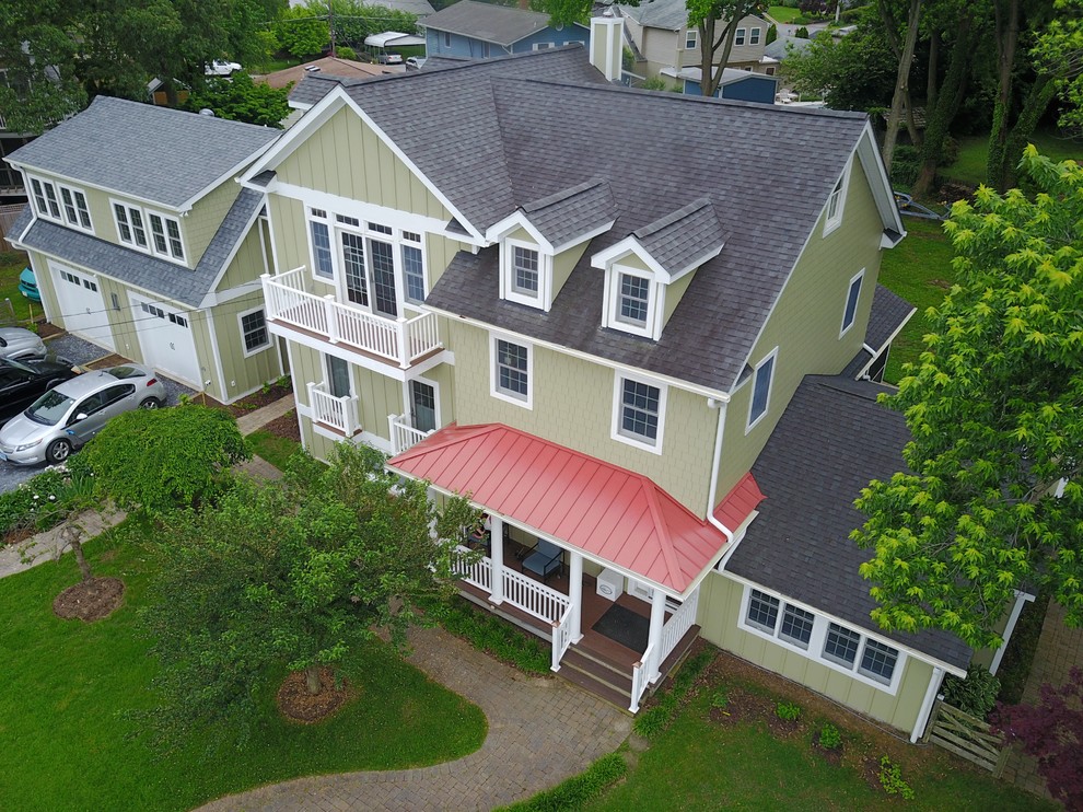 Green two-story metal flat roof photo in DC Metro with a shingle roof