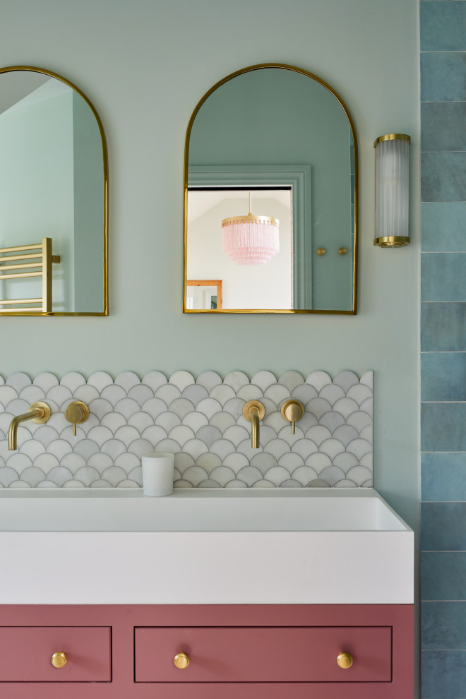Example of a transitional blue tile and gray tile double-sink bathroom design in London with an integrated sink, a freestanding vanity, flat-panel cabinets, blue walls and white countertops
