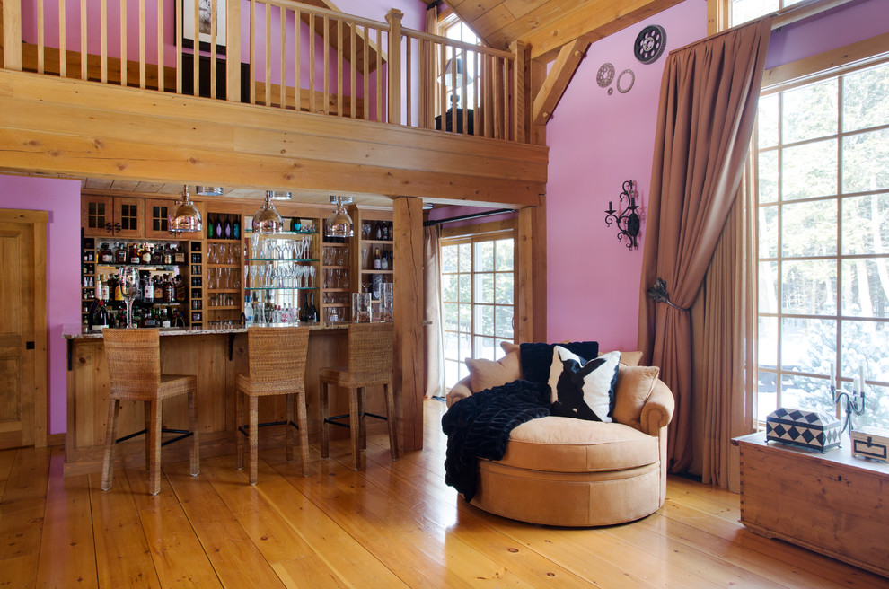 This is an example of a traditional family room in Portland Maine with a home bar, pink walls and no tv.