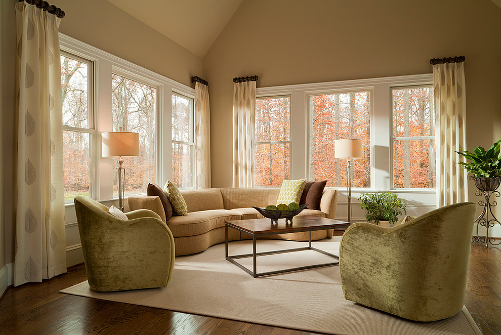 Photo of a mid-sized contemporary formal open concept living room in Charlotte with beige walls and medium hardwood floors.