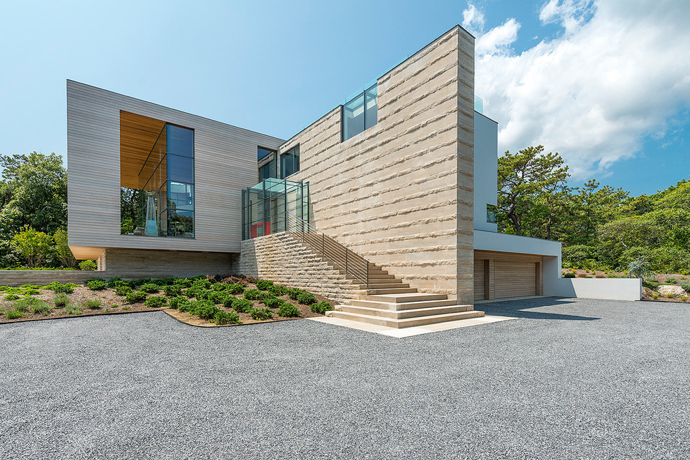 Contemporary beige house exterior in New York with mixed siding and a flat roof.