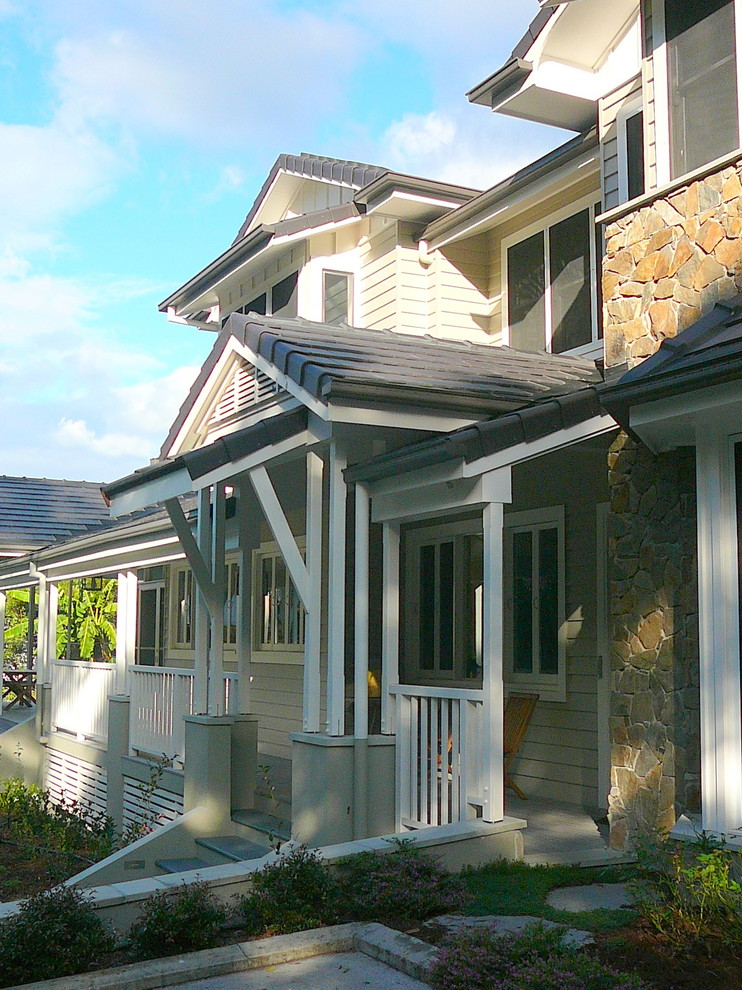 Inspiration for a large traditional two-storey white exterior in Brisbane with wood siding.