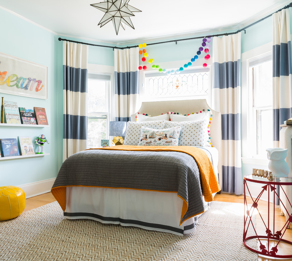 This is an example of a beach style gender-neutral kids' bedroom for kids 4-10 years old in Boston with blue walls.