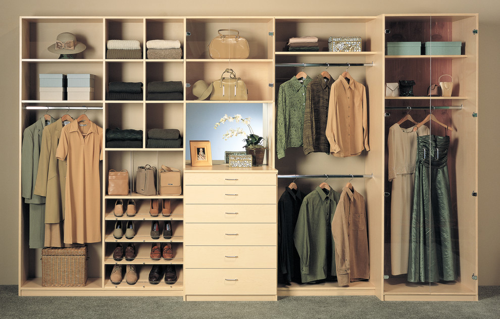 Design ideas for a mid-sized contemporary gender-neutral built-in wardrobe in Los Angeles with flat-panel cabinets, light wood cabinets and carpet.