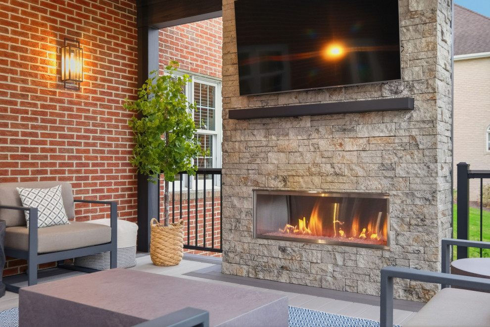 Mid-sized transitional backyard second story mixed material railing deck photo with a fireplace and a roof extension