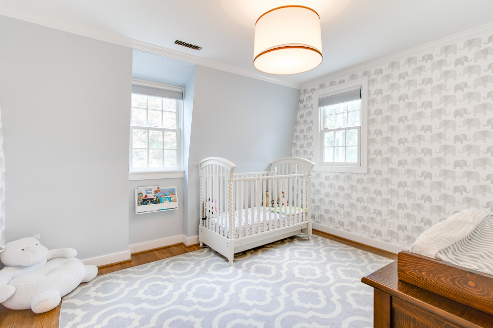Medium sized contemporary nursery in Richmond with white walls, medium hardwood flooring and wallpapered walls.