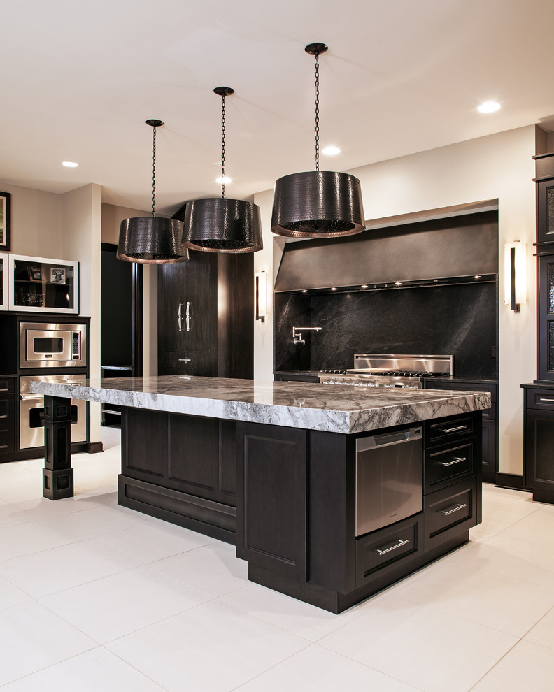 This is an example of a large traditional u-shaped kitchen in Other with black cabinets, granite benchtops, black splashback and with island.