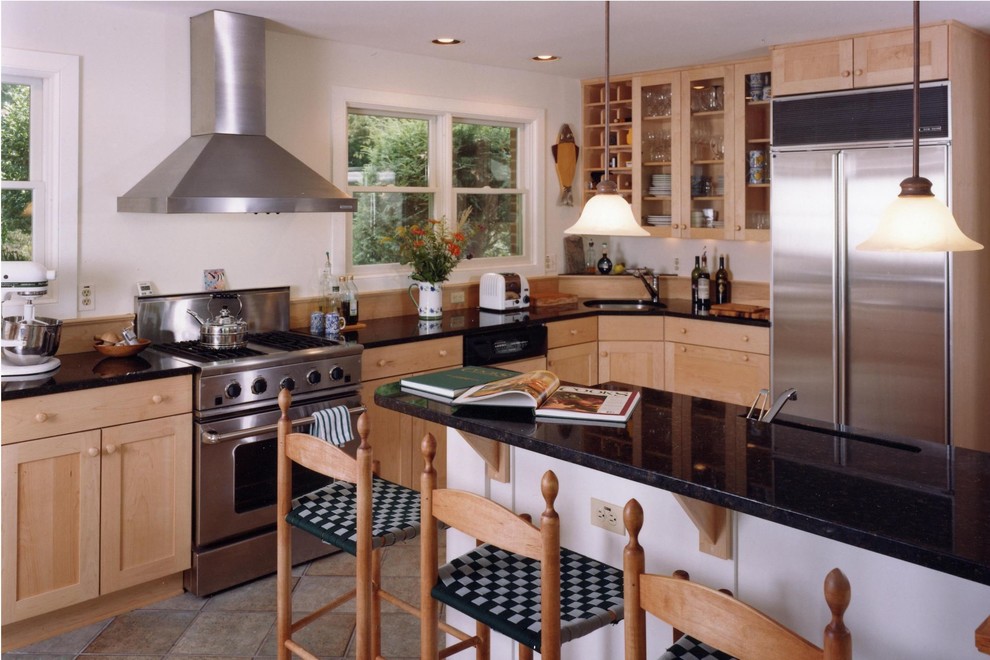 Example of a mid-sized transitional l-shaped ceramic tile enclosed kitchen design in Baltimore with a drop-in sink, recessed-panel cabinets, light wood cabinets, granite countertops, beige backsplash, stainless steel appliances, white walls and an island