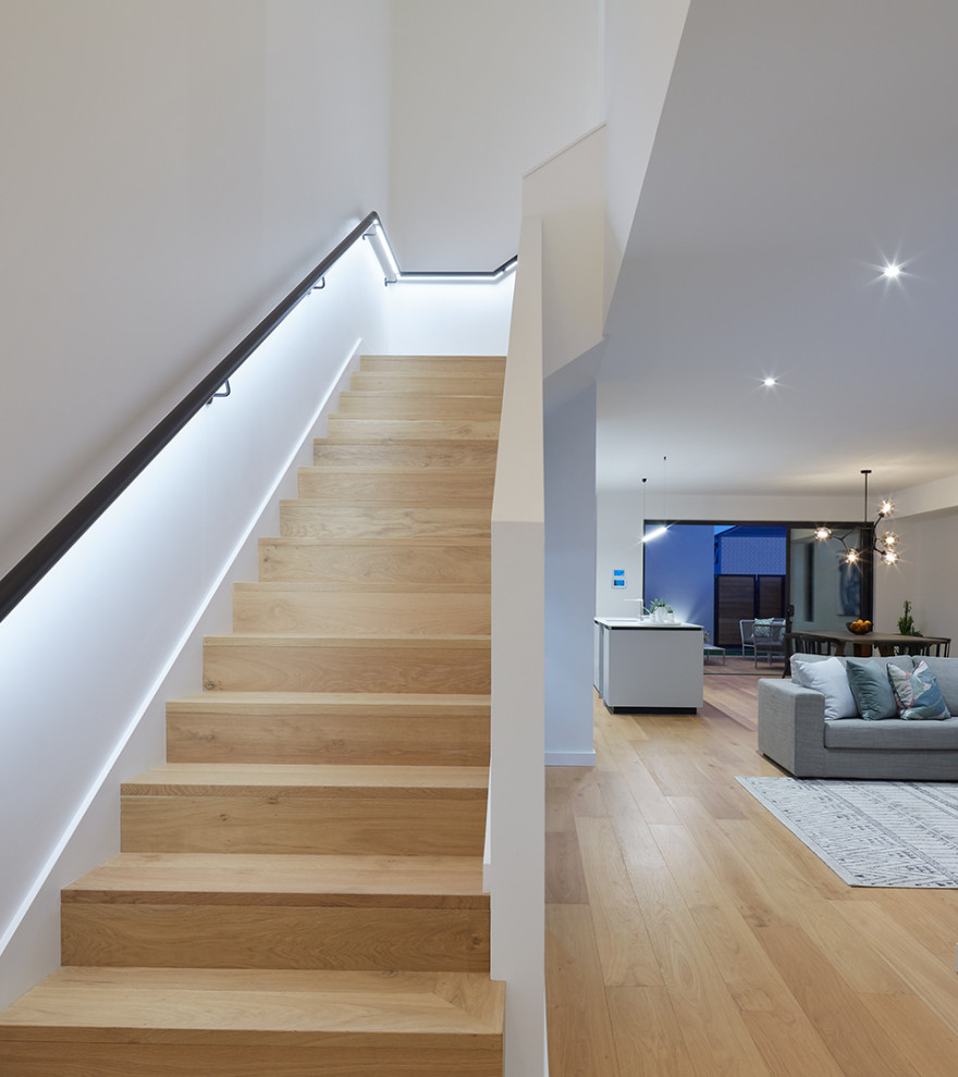 Photo of a mid-sized contemporary wood l-shaped staircase in Perth with wood risers and metal railing.