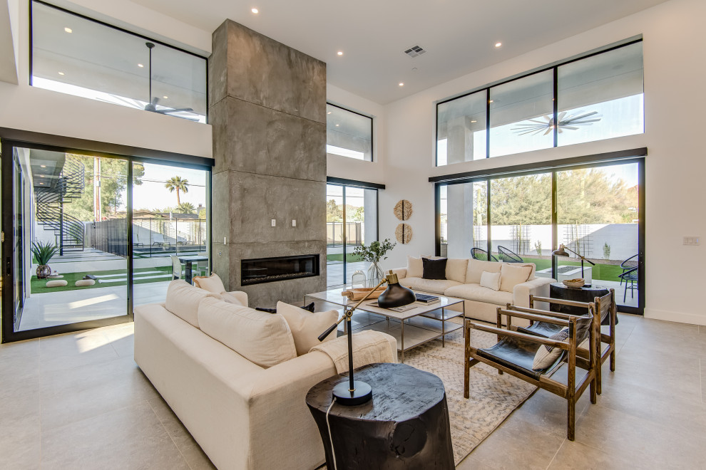 This is an example of a large contemporary open concept living room in Phoenix with a ribbon fireplace.