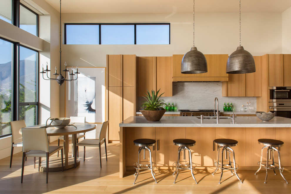 Inspiration for a contemporary kitchen in Los Angeles with an undermount sink, flat-panel cabinets, medium wood cabinets, white splashback, stainless steel appliances, medium hardwood floors and with island.