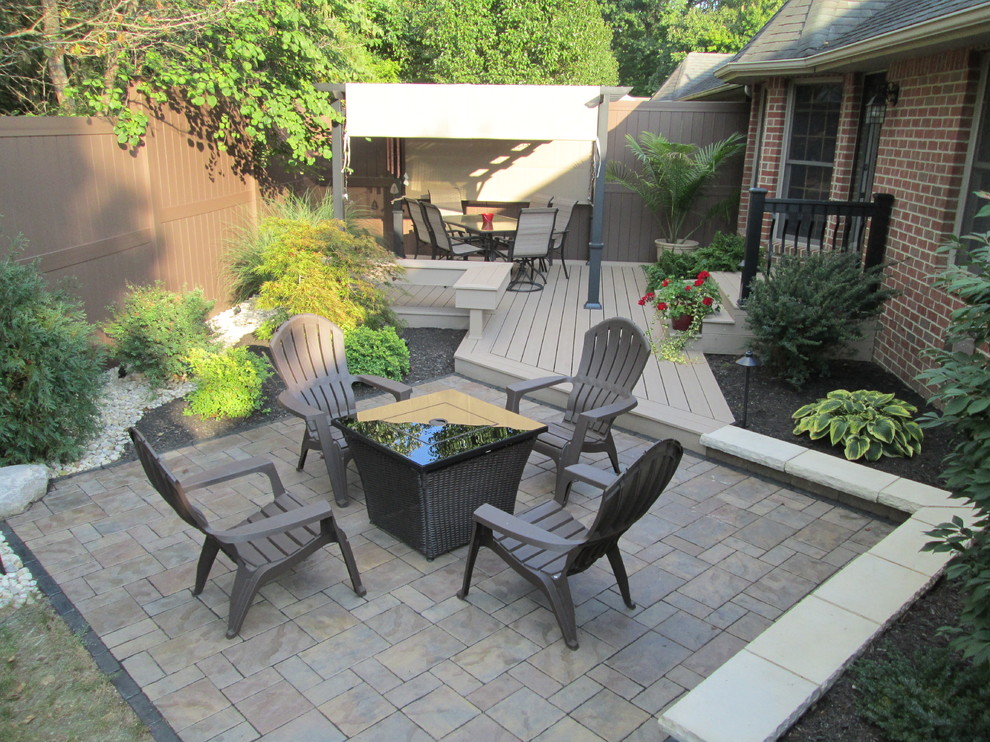 Small transitional backyard patio in Other with concrete pavers and no cover.