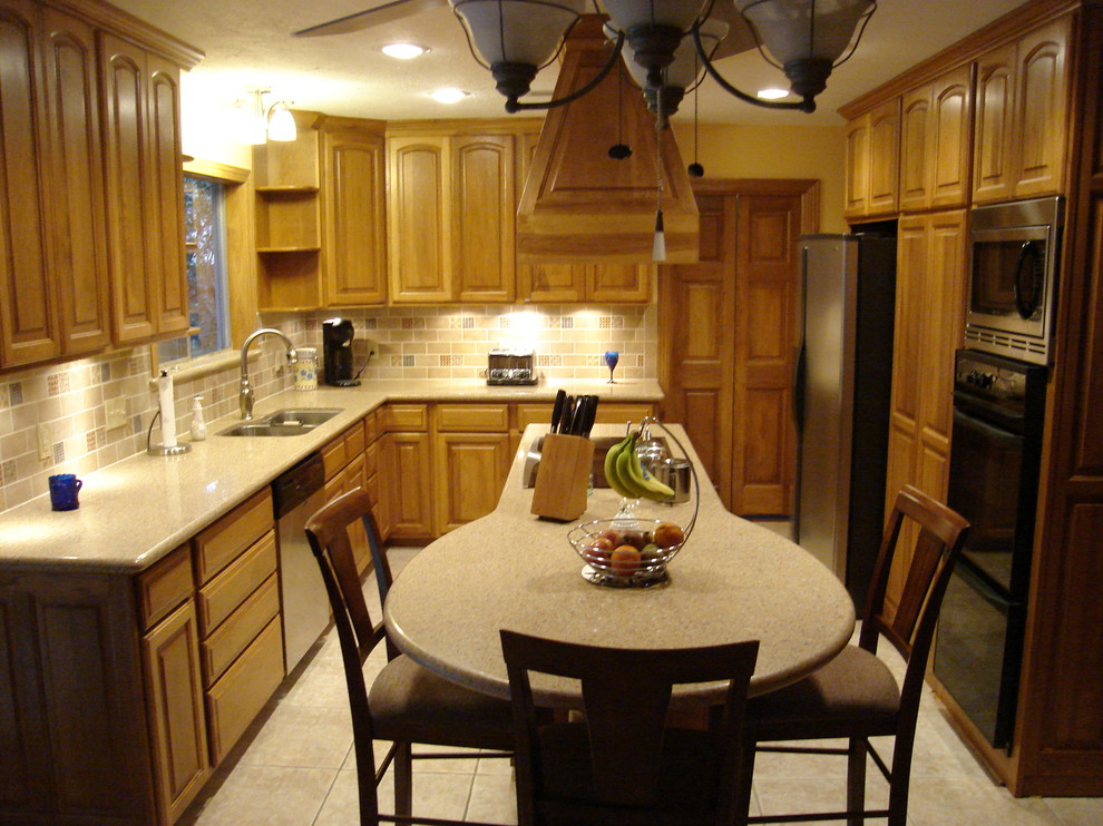 Eat-in kitchen - mid-sized transitional l-shaped ceramic tile eat-in kitchen idea in Houston with a double-bowl sink, raised-panel cabinets, light wood cabinets, solid surface countertops, multicolored backsplash, subway tile backsplash, stainless steel appliances and an island