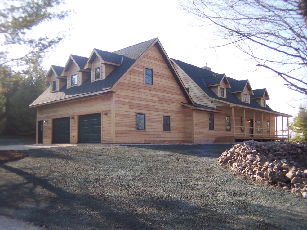 Inspiration for a mid-sized rustic beige two-story wood gable roof remodel with a shingle roof