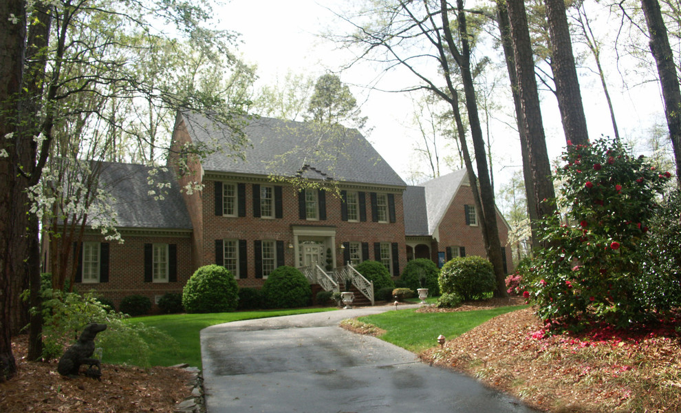 Design ideas for a large traditional two-storey brick red exterior in Raleigh.