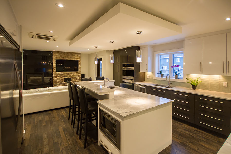 Inspiration for a large transitional l-shaped dark wood floor open concept kitchen remodel with an undermount sink, flat-panel cabinets, white cabinets, granite countertops, green backsplash, glass tile backsplash, stainless steel appliances and an island