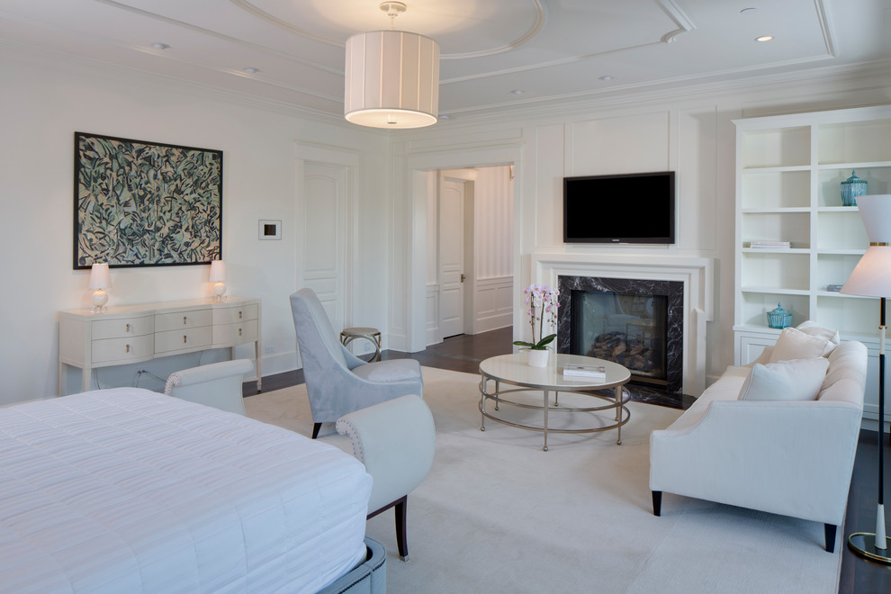 This is an example of an expansive traditional master bedroom in Los Angeles with white walls, carpet, a standard fireplace, a stone fireplace surround and white floor.
