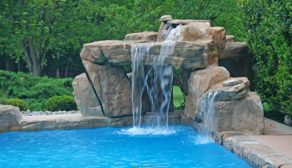 Inspiration for a transitional backyard stone natural pool fountain remodel in Miami